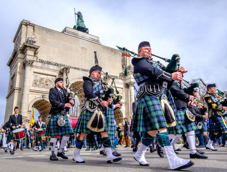 MUNICH - MARCH 11: People celebrating the annual national irish holiday St. Patricks day marching in the old town in munich, germany on  March 11, 2018のeditorial素材