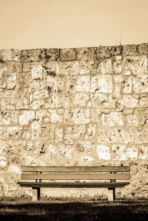 old bench in front of a wallの写真素材