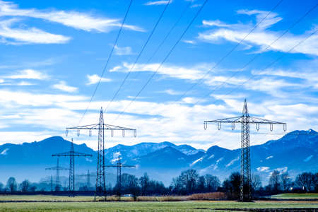 modern electricity pylons at a field near romeの写真素材