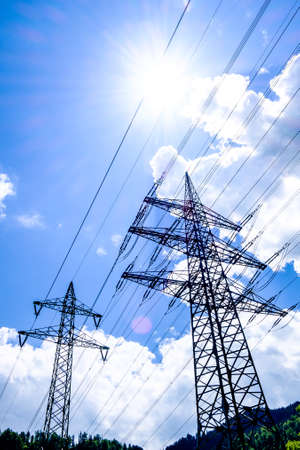 modern electricity pylons at a field near romeの写真素材