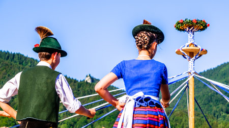 BAD WIESSEE, GERMANY - JULY 19: Bavarian dancing group at a summer festival showing a traditional ribbon dance in Bad Wiessee at july 19, 2016のeditorial素材