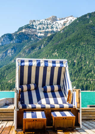 hooded beach chairs at a lakeの写真素材