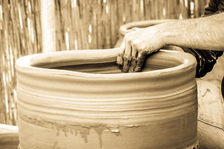 potter making a ceramic - photo