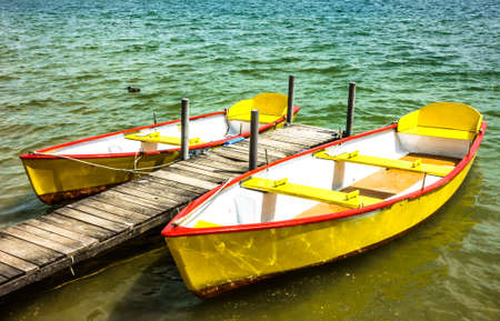 old row boats at a lakeの写真素材
