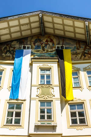 typical bavarian flag in the famous village bad toelz - old townの写真素材