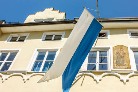 typical bavarian flag in the famous village bad toelz - old townの写真素材