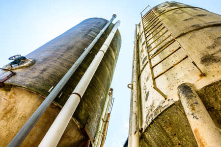 old silo tanks in front of blue sky