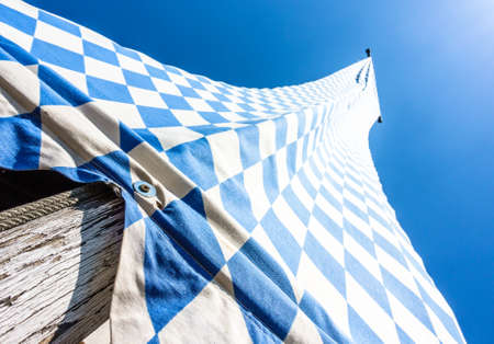 the bavarian flag in front of blue skyの写真素材