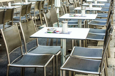 table and chairs at a sidewalk restaurant