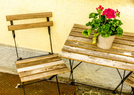 table and chairs at a sidewalk restaurant