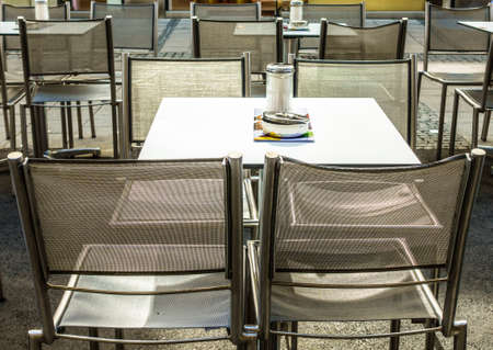 table and chairs at a sidewalk restaurant