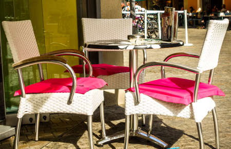 table and chair at a sidewalk cafeの写真素材