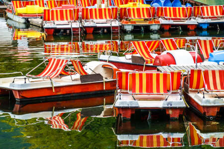 old pedal boats at a lakeの写真素材