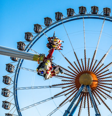 Munich, Germany - October 4: people and fairground rides at the biggest folk festival in the world - the oktoberfest on oktober 4, 2018 in munich.のeditorial素材