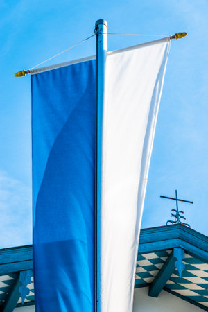 typical bavarian flag in the famous village bad toelz - old townのeditorial素材
