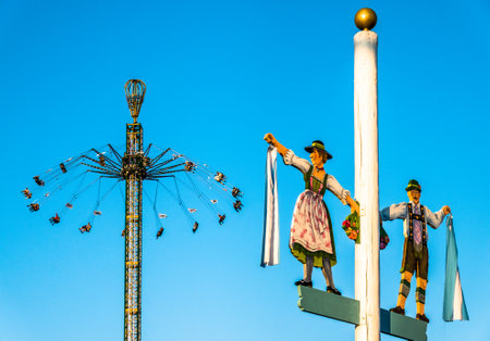 Munich, Germany - September 30: people and fairground rides at the biggest folk festival in the world - the oktoberfest on september 30, 2018 in munich.のeditorial素材