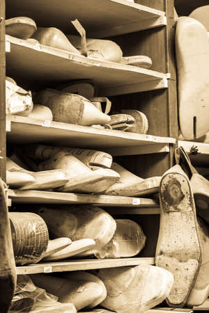 old shoe lasts at a shoemakerの写真素材