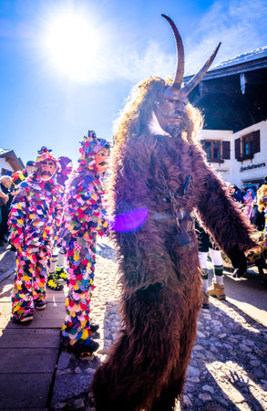 Mittenwald, Germany - February 28: Machkera is a traditional disguise with large wooden larvae, here shown at a parade on Feb 28, 2019 in Mittenwald, Germanyのeditorial素材