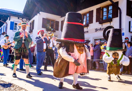 Mittenwald, Germany - February 28: Machkera is a traditional disguise with large wooden larvae, here shown at a parade on Feb 28, 2019 in Mittenwald, Germanyのeditorial素材