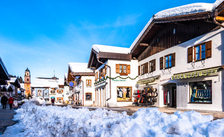 Mittenwald, Germany - January 16: people in the famous old town of mittenwald - karwendel mountains at the background, bavaria/germany on January 16, 2019のeditorial素材