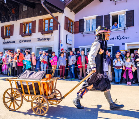 Mittenwald, Germany - February 28: Machkera is a traditional disguise with large wooden larvae, here shown at a parade on Feb 28, 2019 in Mittenwald, Germanyのeditorial素材