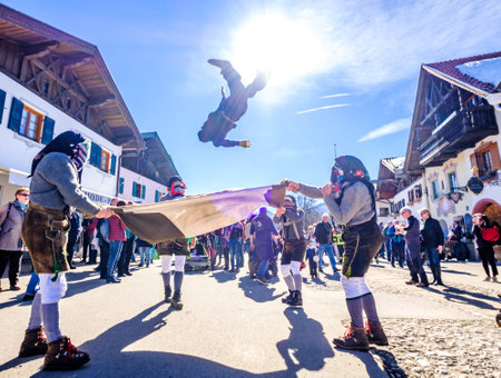 Mittenwald, Germany - February 28: Machkera is a traditional disguise with large wooden larvae, here shown at a parade on Feb 28, 2019 in Mittenwald, Germanyのeditorial素材