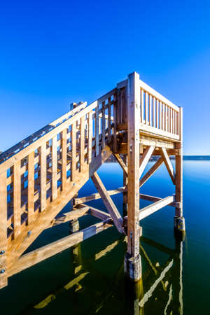 wooden diving platform at a lakeの写真素材
