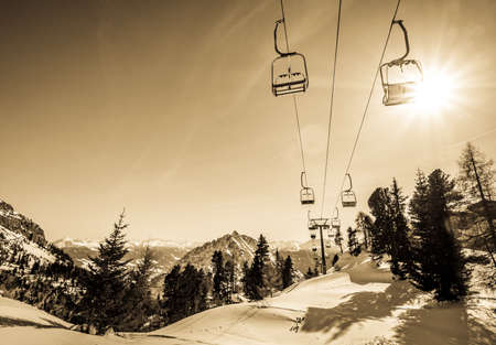 mountains with modern ski lift chairs