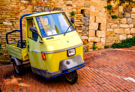 Parma, Italy - August 20: typical old Piaggio APE transpoerter car at the old town on August 20, 2014 in Parma, Italyのeditorial素材