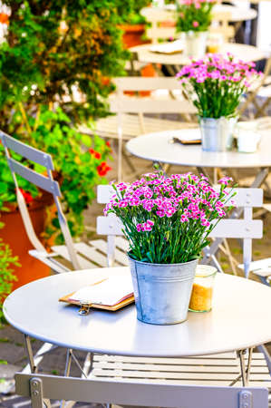 table and chairs at a sidewalk cafe