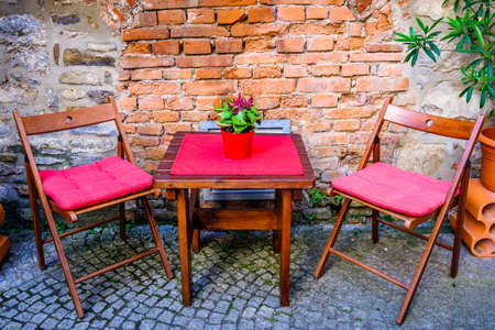 table and chairs at a sidewalk cafeの写真素材