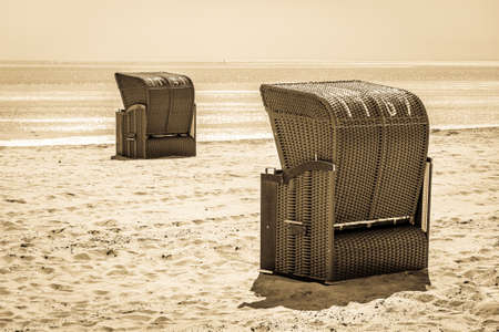 typical hooded beach chairs at a beach in north germanyの写真素材