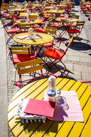table and chairs at a sidewalk cafeの写真素材