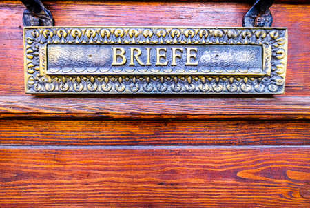old mail slot at a  wall in germany - translation: letterの写真素材