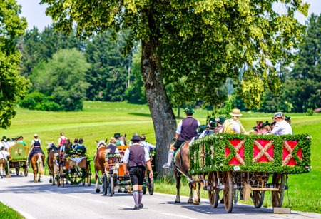 Dietramszell, Germany - July 20: people with traditional clothes at the annual horse-carriage procession with blessing, named leonhardifahrt on July 20, 2019 in Dietramszell, germanyのeditorial素材