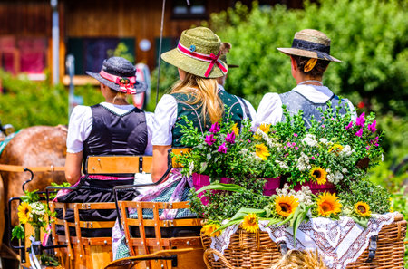 Dietramszell, Germany - July 20: people with traditional clothes at the annual horse-carriage procession with blessing, named leonhardifahrt on July 20, 2019 in Dietramszell, germanyのeditorial素材