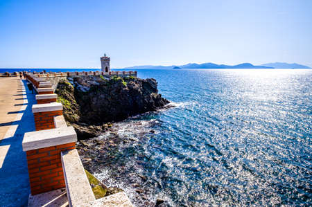 famous lighthouse at the harbor of piombino in italyの写真素材