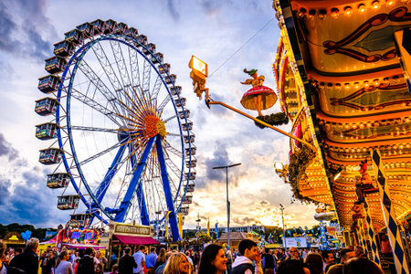 Munich, Germany - September 27: visitors, beertents and fairground rides on the oktoberfest in munich at September 27, 2019のeditorial素材