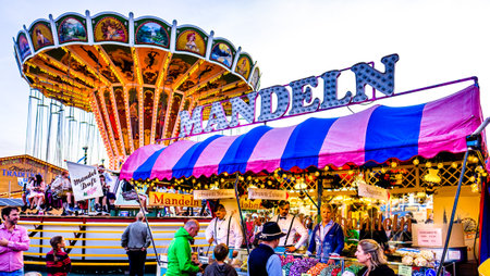 Munich, Germany - September 28: visitors, beertents and fairground rides on the oktoberfest in munich at September 28, 2019のeditorial素材