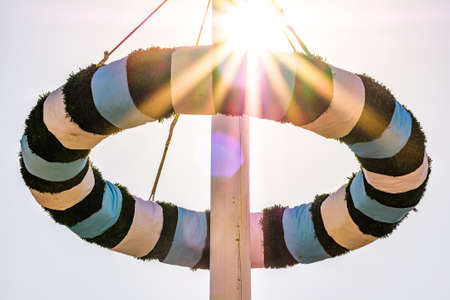typical bavarian maypole in front of blue skyの写真素材