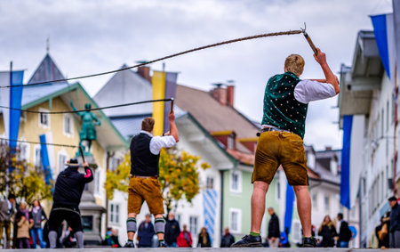 Bad Toelz, Germany - November 6: coachman with traditional clothes and popping whip at the annual leonhardifahrt procession on November 6, 2019 in bad toelz, germanyのeditorial素材