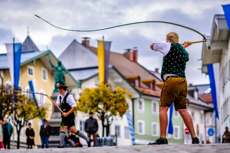Bad Toelz, Germany - November 6: coachman with traditional clothes and popping whip at the annual leonhardifahrt procession on November 6, 2019 in bad toelz, germanyのeditorial素材