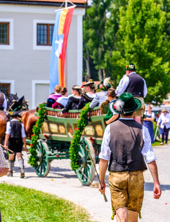 Dietramszell, Germany - July 20: people with traditional clothes at the annual horse-carriage procession with blessing, named leonhardifahrt on July 20, 2019 in Dietramszell, germanyのeditorial素材