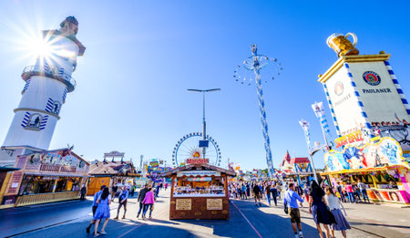 Munich, Germany - October 1: people and fairground rides at the biggest folk festival in the world - the oktoberfest on october 1, 2019 in munich.のeditorial素材
