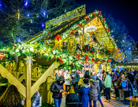 Munich, Germany - December 3: people and typical sales booth at the christmas market on December 3, 2019 in Munich, Germanyのeditorial素材