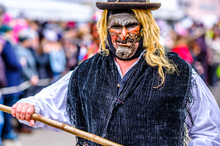 Mittenwald, Germany - February 20: participants of a parade with traditional disguise with large wooden masks and historic costumes called 'maschkera' on February 20, 2020 in Mittenwaldのeditorial素材
