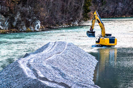 excavator working at a riverbed - photo