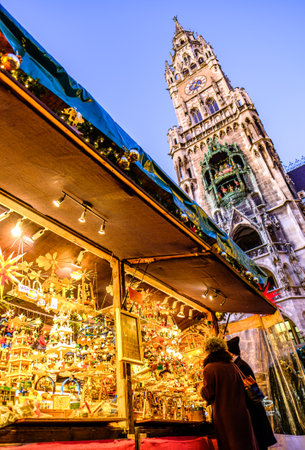 Munich, Germany - December 3: people and typical sales booth at the christmas market on December 3, 2019 in Munich, Germanyのeditorial素材