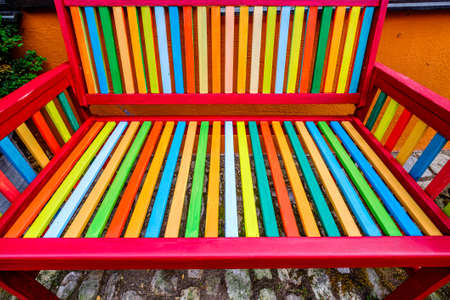 typical wooden parkbench at a patioの写真素材