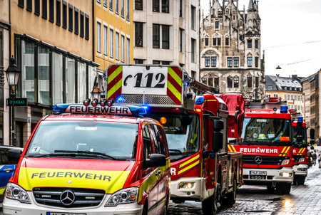 Munich, Germany - February 11: typical german fire trucks and police car in Munich theatinerstrasse...